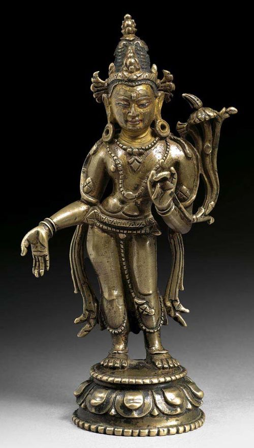 BRASS BRONZE STANDING FIGURE OF AVALOKITESHVARA. The face and hair with ritual paint. Palace style. Tibet, ca. 13th century. H 18.3 cm.
