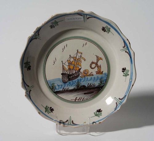 PLATE, probably Nevers, 2nd half of the 18th century. With central medallion enclosing a ship in blue, manganese and ochre yellow. D 23cm. Minor chip to rim and typical flaking of the glaze. Provenance: private collection, South Germany