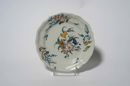 FLORAL PAINTED PLATE, probably  Sinceny, mid 18th century. In green, blue and yellow, heightened in iron red. D 25cm. Provenance: private collection, South Germany