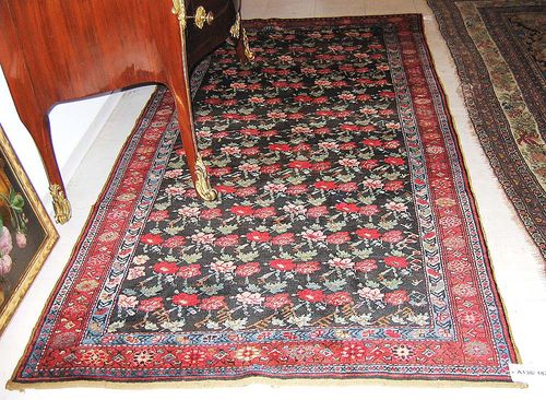 KARABACH old. Black central field patterned with small flowers in red, pink and green. Red border. Good condition. 274x130 cm.