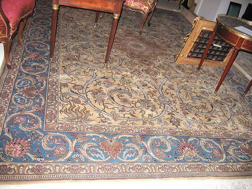 TABRIZ. Beige central field with floral medallion finely patterned with palmettes. Blue border similarly patterned. Good condition. 394x283 cm.