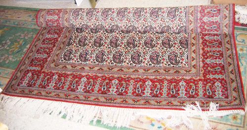 GHOM, old. White central field, decorated with Boteh motifs in blue tones, red border, good condition, 210x140 cm.