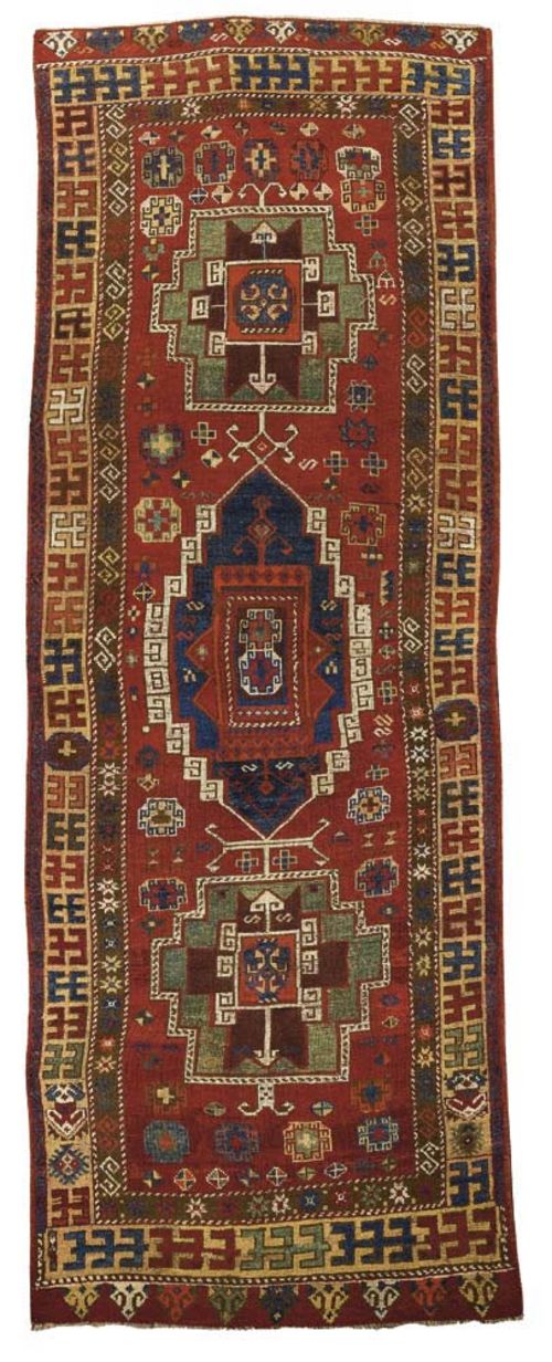 KONJA runner, antique. Red central field with three medallions in green and blue, geometric patterned with star motifs, yellow-green border, professionally restored, 320x115 cm.