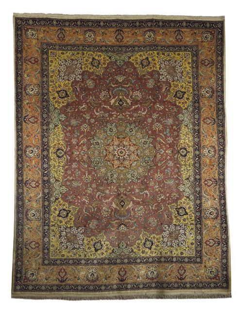 TABRIZ silk. Old rose central field with yellow corner motifs and floral central medallion, the whole carpet lavishly decorated with plants and birds, apricot coloured border, good condition, 313x244 cm.