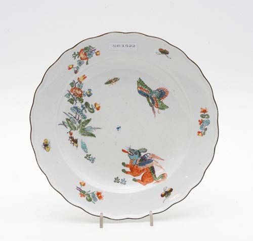 KOREAN LION PLATE, Meissen, circa 1740.'Alter Ausschnitt' form. Painted in Kakiemon style with flying herons, winged dragons and peonies. Underglaze blue sword mark, impressed number 61. D 23.5cm. Somewhat rubbed. Provenance: from a private collection, Solothurn