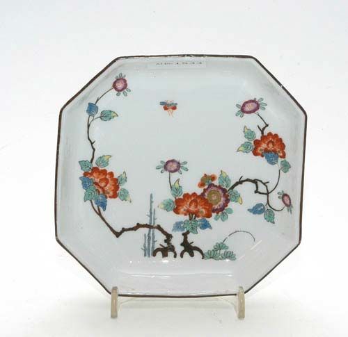 OCTAGONAL DISH WITH KAKIEMON STYLE DECORATION, Meissen, circa 1745.Two flowering branches in Kakiemon colours, heightened in gold, and three bamboo stems in light blue. Brown line on the edge. Underglaze blue sword mark, impressed number 29. Provenance: from a private collection, Solothurn