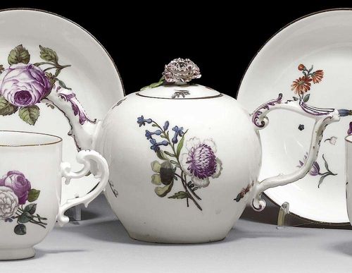 TEAPOT AND COVER, Meissen, circa 1745. Painted with bouquets of Deutsche Blumen, the similarly decorated cover with a flower finial, rims edged in brown, crossed swords in underglaze-blue, slightly chipped.
