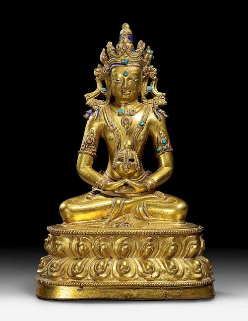 AMITHAYUS.Tibet, 16th century. H 20.5 cm. Seated with rich head ornament on lotus throne. Gilt bronze with remains of cold gilding on the face, and with blue-coloured hair. Some of the gemstones replaced with glass. Base plate missing.