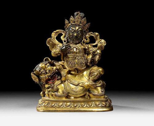 VAISHRAVANA.Mongolia, 18th century H 17.5 cm. Gilt bronze. The hands and face with beard without gilding. Remains of green colour on the lion's mane. The plinth base and lion's tail are missing.