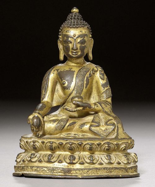 A SMALL GILT COPPER ALLOY FIGURE OF THE MEDICINE BUDDHA. Tibet, 14th c. Height 11 cm.