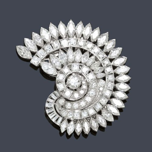 A DIAMOND BROOCH, circa 1935. Platinum. Very attractive brooch modeled as stylized ammonite, entirely set with 37 navette diamonds, 27 French-cut diamonds, 8 baguette-cut diamonds and 23 brilliant-cut and old European-cut diamonds of a total of ca. 19.00 ct. White gold clasp. With the original case.