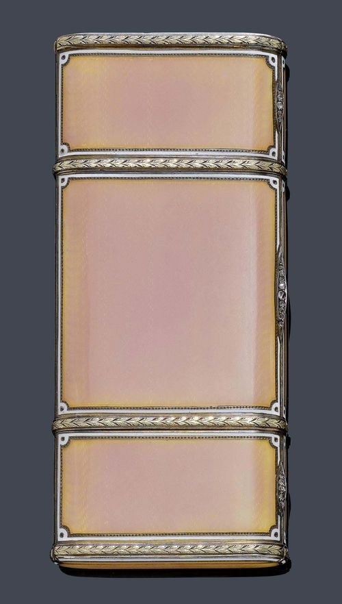 AN ENAMEL AND DIAMOND NECESSAIRE DE SOIR, St. Petersburg, 3. ARTEL, circa 1910. Gilded silver 88 Zolotniki. A long quadrangular case, the waved textured panels applied with translucent pink enamel, the edges with applied white enamel. A three parts top opening to reveal three compartments: one of them with 2 gold lipstick canisters, later. The central compartment with two open compartments, one with a hinged panel, the last compartment with two various size coin holders. The three pushpieces set with 19 rose-cut diamonds. Ca. 11.7 x 5.1 x 1.6 cm. With the seller's mark Sumin. Provenance: - A La Vieille Russie, New York - Sotheby's New York, 16.4.07, Lot 57 - Private collection