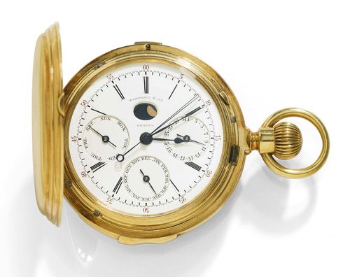 SAVONNETTE POCKET WATCH, CALENDAR WITH MOON PHASE, RATTRAPANTE, 1/4 REPEATER, TIFFANY. Yellow gold 750. Polished case No. 13745 signed Tiffany & Co. Cover decorated with a black enamelled anchor motif with inscription. Enamelled dial, Roman numerals and blue-Breguet hands, outer 60 minute division with numbers in red, date at 3h, month at 6h, day of the week at 9h, oval window with moon phase at 12h, large central second hand and rattrappante sweep second hand, signed Tiffany & Co. Geneva. Glass-covered lever movement with Breguet balance spring, bimetallic balance, repeater with strike on two gong springs, wolf tooth's winding, signed Tiffany & Co. Geneva, No. 13745. D 55 mm. Movement probably by Louis Audemars for Tiffany.