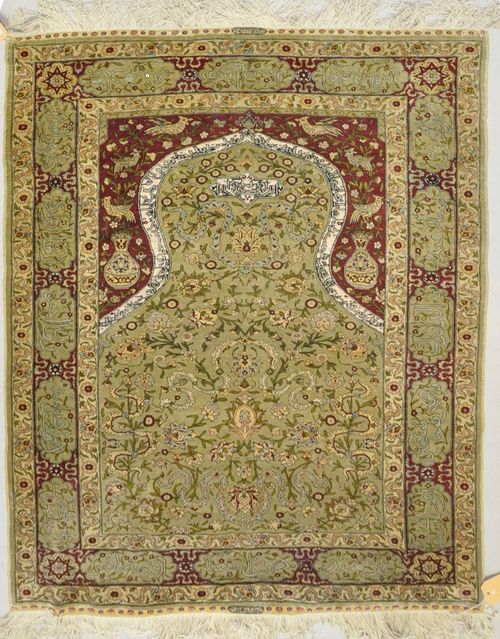 HEREKE SILK PRAYER.Grey mihrab with red spandrels, patterned with trailing flowers and birds, slight wear, 103x156 cm.