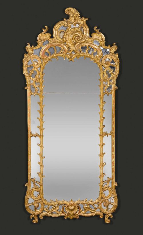 IMPORTANT MIRROR "AUX CARTOUCHES",Regence/Louis XV, Paris circa 1730/40. Pierced, richly carved and gilt wood. The mirror plate in two parts. H 240 cm, W 110 cm. Provenance: from a highly important Swiss private collection.