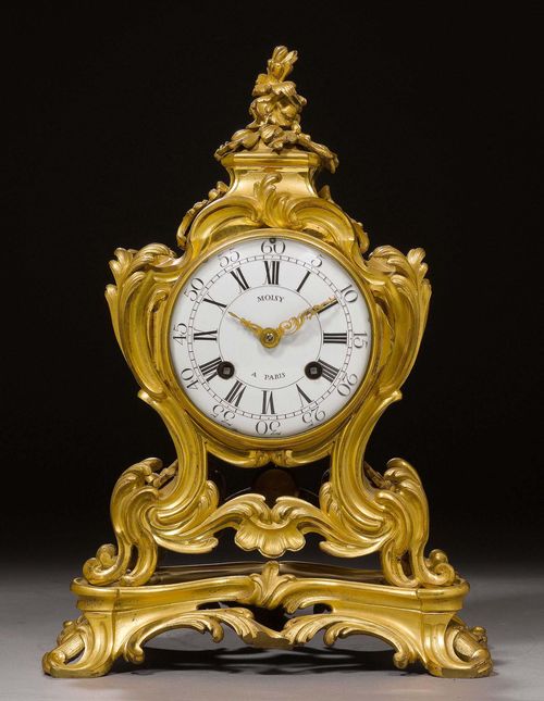 MANTEL CLOCK,Louis XV, the dial signed MOISY A PARIS (Jean Moisy, active 1753-1782), Paris circa 1750. Matte and polished gilt bronze. Enamel dial and verge escapement striking the 1/2 hours on bell. 28x18x36 cm. Provenance: from a highly important Swiss private collection