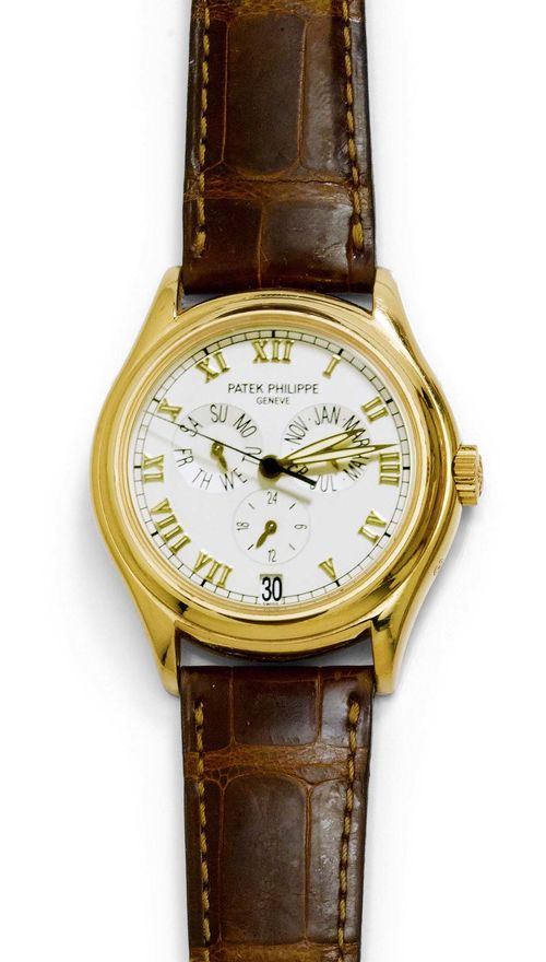 GENTLEMAN'S WRISTWATCH, AUTOMATIC, PATEK PHILIPPE ANNUAL CALENDAR, 1990s. Yellow gold 750. Ref. 5035. Polished case No. 2999859 with slanted lunette and attaches, screw-down exhibition back. Textured dial, appliqued Roman numerals and gold-coloured hands, central second, month at 3h, day-of-the-week at 9h, 24 hour indication at 6h, date at 6h. Automatic, movement No. 3055328, Cal. 315/198, Gold rotor, Gyromax balance. Brown leather band with original clasp. D 36.5 mm.