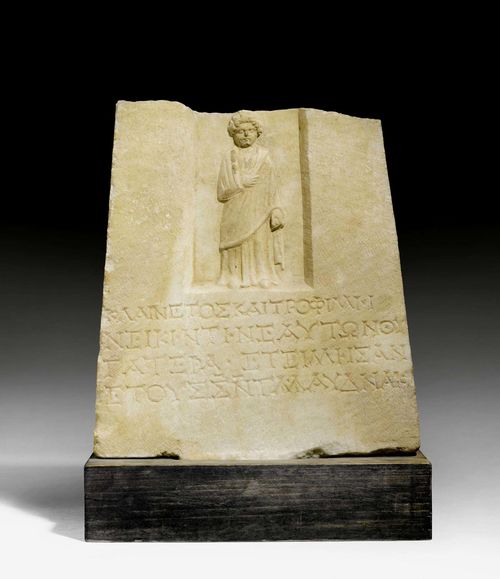 FRAGMENT OF A TOMBSTONE, Roman, Asia Minor, 1st/2nd century AD. Light marble. Greek inscription below figure of a girl. Mounted on a wooden base. H with base 45 cm. Provenance: - Sam Dormont, Tel Aviv. - Swiss private collection, acquired 1978.