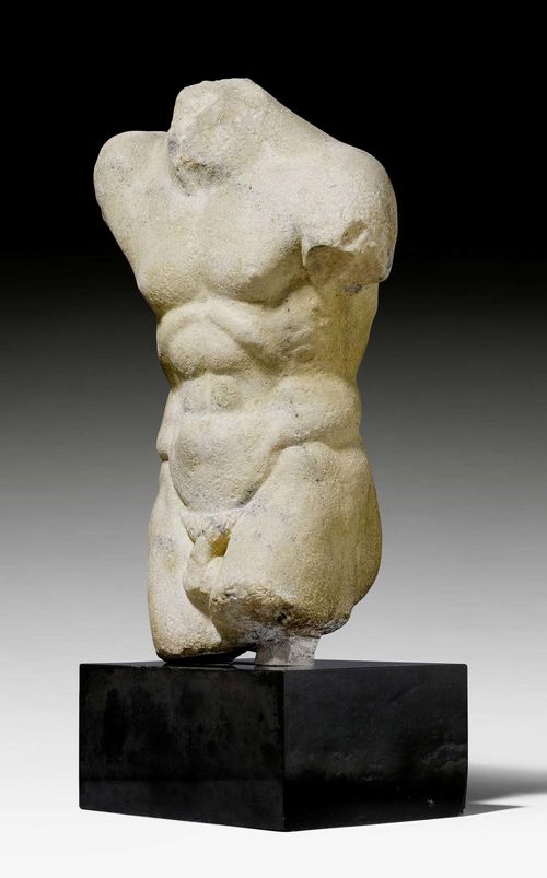 TORSO OF A MAN,Roman, after the so-called "Ruler with Lance", probably 2nd century A.D. Light brown, dark-gray speckled marble. On black stone plinth. H 62 cm.