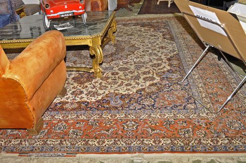 ISFAHAN alt.White ground with a central medallion and blue corner motifs, finely patterned with trailing flowers and palmettes, rust coloured edging, one corner damaged, 307x410 cm.