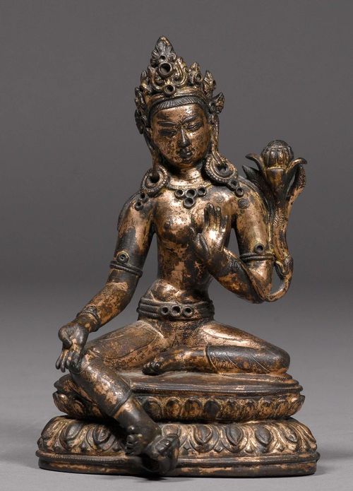 A GILT COPPER ALLOY FIGURE OF THE GREEN TARA. Tibet, 15th/16th c. Height 13.5 cm. Colour changes due to fire.
