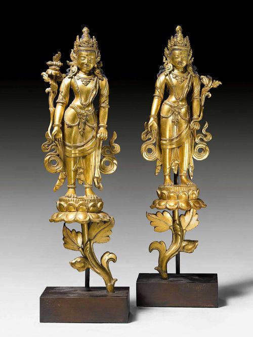 TWO GILT COPPER ALLOY STANDING BODHISATTVAS ON LOTOS BLOSSOMS. Nepal, 18th c. Height 28 cm.