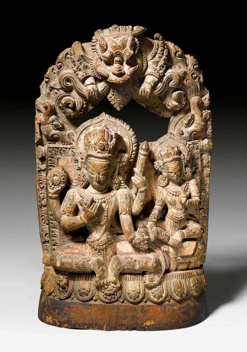 A WOODEN STELE OF VISHNU AND MAHALAKSHMI. Nepal, 18th c. Height 38 cm. Some damages.