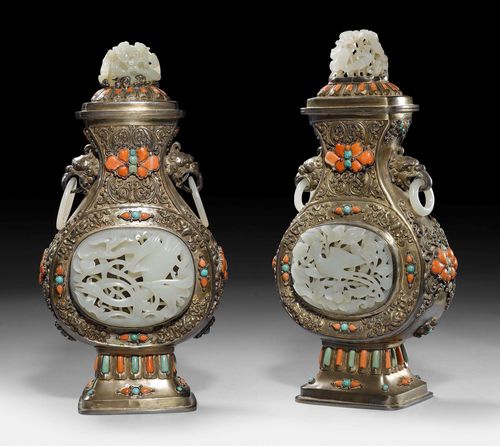 A PAIR OF MAGNIFICENT SILVER VASES AND COVERS WITH JADE, CORAL AND TURQUOISE INLAYS. Mongolia, heigth 29 cm. The jade carvings not identical and possibly older than the vases.