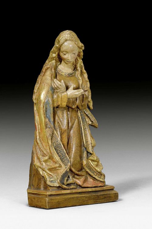 THE ANNUNCIATION TO THE BLESSED VIRGIN MARY, Renaissance, Brussels ca. 1480. Carved oak, verso flattened and painted. Mary kneeling with long, open hair and eyes downcast, arms folded over her chest. The lining of the coat inscribed with the words of the angel AVE MARIA GRATIA PLENA DOMINUS TECUM. Mounted on a later base. Painting retouched. H 33 cm. Provenance: - Collection Albert and Hedwig Ullmann, Frankfurt a. M. - Dr. Arthur Kauffmann, London (up until 1951). - Collection Emil G. Bührle, Zurich.