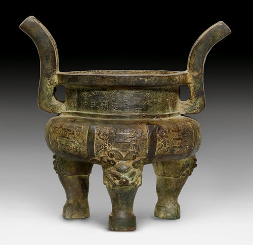A BRONZE TRIPOD CENSER WITH UPRIGHT HANDLES AND LION-HEAD FEET, SHOWING TRIGRAMS AND CLOUDS ON A LEIWEN GROUND, WITH INCISED INSCRIPTION AND  CHENGHUA DATE.