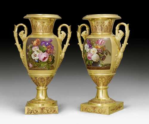 PAIR OF VASES WITH HANDLES, Empire/Restoration, by DARTE FRERES (Darte Frères Paris 1801-1833), after drawings by C. PERCIER (Charles Percier, 1764 Paris 1838) and P.F.L. FONTAINE (Pierre François Léonard Fontaine, Pontoise 1762-1853 Paris), Paris ca. 1825/35. Fine and colourfully painted porcelain, probably from the Manufactory Nast. Large amphora-shaped vase with broad neck and shaped lip, the sides with handles designed as acanthus leaves and rams' heads. Painted with bouquets of flowers, verso large vase, bouquet of flowers, cornucopias, angels and leaves. Additionally finely decorated with rosettes, cartouches and leaves. H 60 cm. Provenance: from a Swiss private collection.