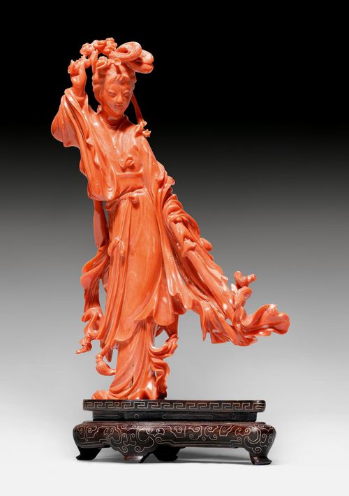 A CORAL CARVING OF A LADY WITH A SWORD.