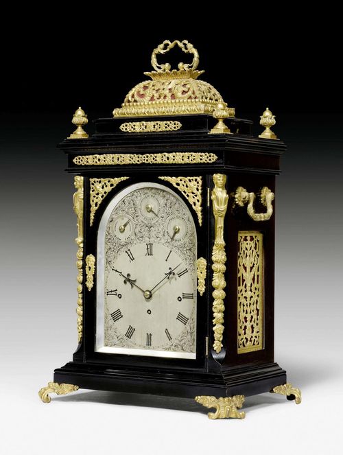 MANTEL CLOCK WITH CARILLON,George II/III, England circa 1750. Ebonized wood with matte and polished gilt bronze. Finely engraved silver-plated dial with Roman hour numerals and 3 setting adjustments for the carillon. Fine brass movement with 4/4 striking on gong and 8 bells for the carillon. 41x29x64 cm.