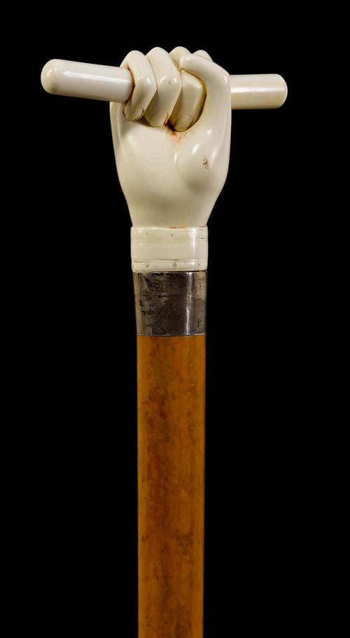 A WALKING STICK WITH HANDLE IN THE FORM OF A HAND,