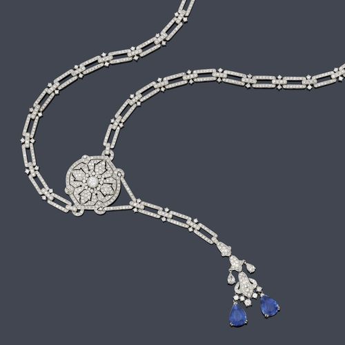 SAPPHIRE AND DIAMOND SAUTOIR. White gold 750, 85g. Elegant, decorative "Y"-shaped necklace in the Art Deco style, of rectangular links connected with bar links, set throughout with a total of 1146 brilliant-cut diamonds. The florally designed pendant set with 2 fine drop-cut sapphires weighing 5.68 ct and 2 drop-cut diamonds, suspended from an open-worked ornament set throughout with 304 brilliant-cut diamonds. Total weight of the diamonds ca. 11.55 ct. L ca. 76 cm.