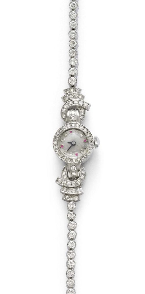DIAMOND LADY'S WRISTWATCH, ca. 1950. White gold 750, 28g. Round case with diamond-set lunette and attaches weighing ca. 1.20 ct. Silver-coloured dial with diamond indices and 4 ruby indices, silver-coloured hands. Hand winder, does not run: resinified. Rivière bracelet set throughout with 30 brilliant-cut diamonds weighing 2.40 ct, L ca. 16.5 cm. D 16 mm.