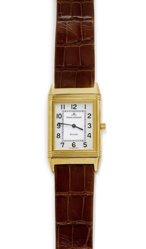 LADY'S WRISTWATCH, JAEGER LE COULTRE, REVERSO. Yellow gold 750. Ref. 250.1.86, new 250.140.862. Rectangular case No. 1828902 with ribbed lunette. Two-tone dial with black Arabic numerals and blued hands. Hand winder, Cal. 846/1. Brown leather band with Jaeger gold clasp. D ca. 39 x 24 mm. With case, warranty, and copy of the insurance estimate, August 2004.