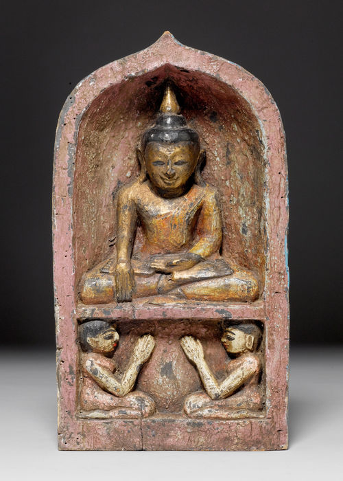 A WOOD AND POLYCHROME LACQUER FIGURE OF THE BUDDHA SEATED IN A NICHE WITH WORSHIPPERS. Burma, 19th c. Height 38 cm.