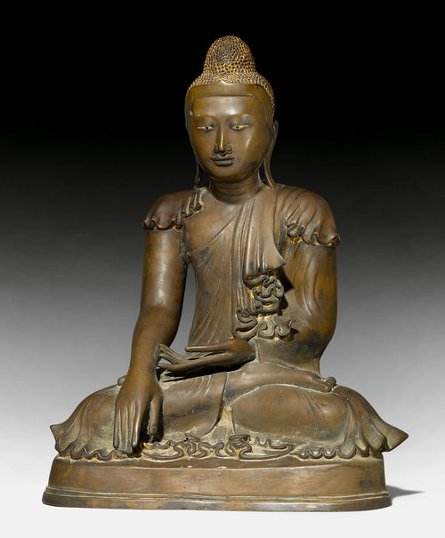 A SEATED BRONZE FIGURE WITH TRACES OF LACQUER GILDING.