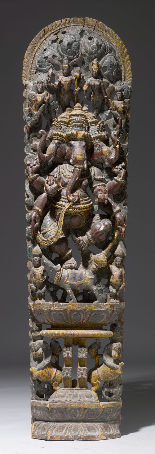 A LARGE WOODEN STELE WITH A THREE-HEADED GANESHA CROWNED BY FOUR GODDESSES, OVER A BOAR ON A LOTUS WITH MAKARAS.