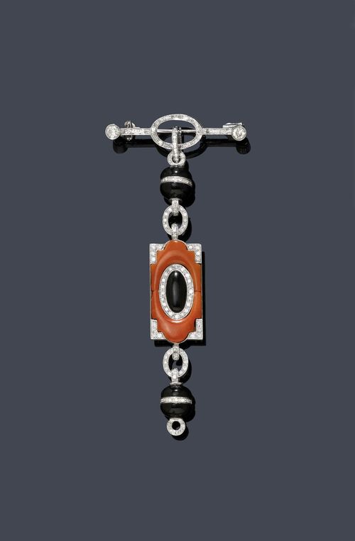 CORAL, ONYX  AND DIAMOND BROOCH /  PENDANT . White gold 585, 15g. Attractive, geometrically designed brooch in the Art Deco style, removable pendant of 1 rectangular ornament set with 2 salmon-pink cut corals and 1 oval onyx, flexibly mounted between 2 onyx beads with a continuous diamond band and with 2 diamond-set, ring-shaped intermediate links. Brooch and pendant additionally set throughout with numerous diamonds weighing ca. 1.40 ct. L ca. 9.5 cm.