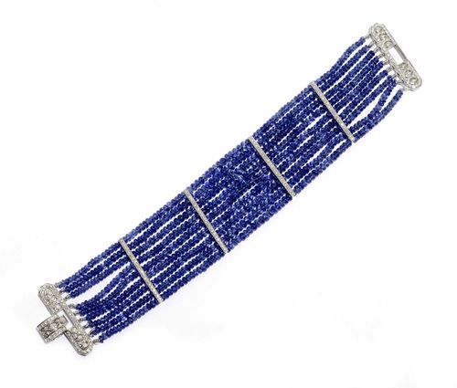 SAPPHIRE AND DIAMOND BRACELET. White gold 750. Classic-elegant, nine-row bracelet of numerous sapphire rondelles of ca. 3 mm Ø weighing ca. 150 ct in total, untreated, connected by 4 brilliant-cut diamond-set barrette intermediate bars. Geometrically designed clasp set throughout with numerous brilliant-cut diamonds. Total diamond weight ca. 2.00 ct. W ca. 3 cm, L ca. 17.5 cm. Matches the previous lot. With GJEPC Report No. I1635CA69818, for the testing of one bead, March 2012.