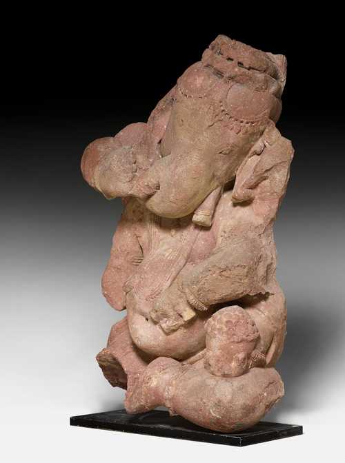 A RED SANDSTONE FIGURE OF THE FOUR ARMED GANESHA.