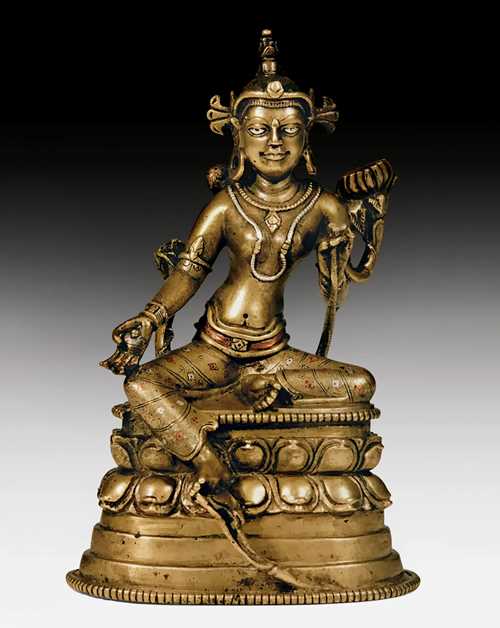 A FINE BRONZE FIGURE OF THE GREEN TARA WITH RICH SILVER AND COPPER INLAYS.