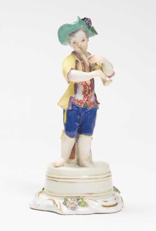 A FIGURE OF A FLUTE PLAYING BOY,