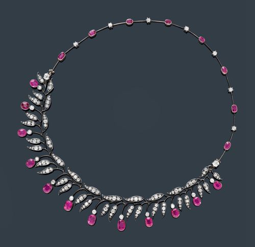 BURMA RUBY AND DIAMOND NECKLACE, Moscow, ca. 1900. Silver over pink gold, 56 zolotniki. Very decorative bar necklace, the back with 8 oval rubies weighing ca. 1.70 ct and 7 old European-cut diamonds weighing ca. 0.30 ct. The removable front decorated with leaves and bud motifs, set with 12 oval, fine Burma rubies weighing ca. 7.20 ct, unheated, and 120 old European-cut diamonds weighing ca. 3.80 ct. Russian mark. L ca. 38 cm. With GGTL Short Report No. 14-B-2465.