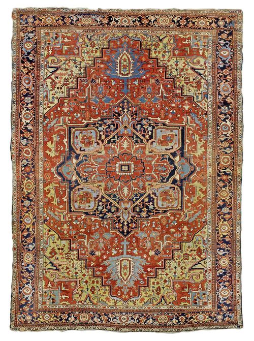HERIZ antique.Red ground with a bulky central medallion, yellow corner motifs, typically patterned, dark blue edging, signs of wear, 290x405 cm.