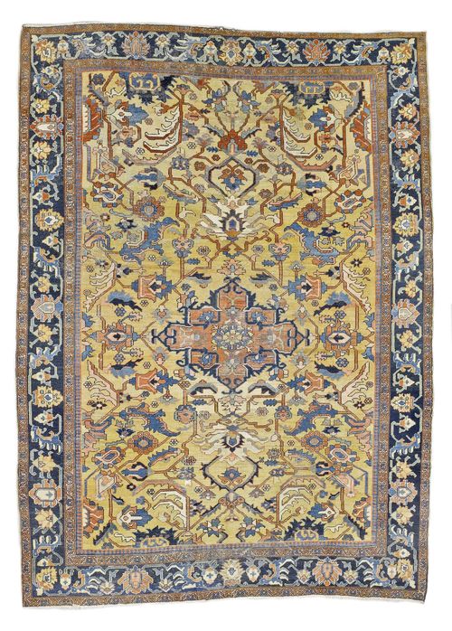 HERIZ SERAPI antique.Yellow central field with a pink central medallion, geometrically patterned with stylized trailing flowers, dark blue border, signs of wear, 305x375 cm.