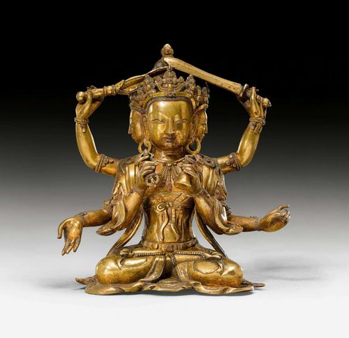 A GILT BRONZE FIGURE OF A SIX ARMED THREE FACED BODHISATTVA. Tibeto-chinese, 17th/18th c. Height 15 cm.