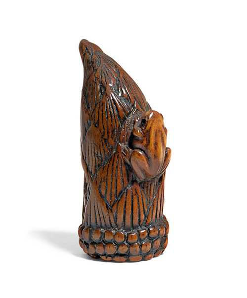 A BOXWOOD NETSUKE OF A BAMBOO SHOOT WITH A FROG.